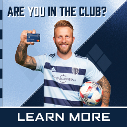 Johnny Russell holding a KC Sporting Debit Card