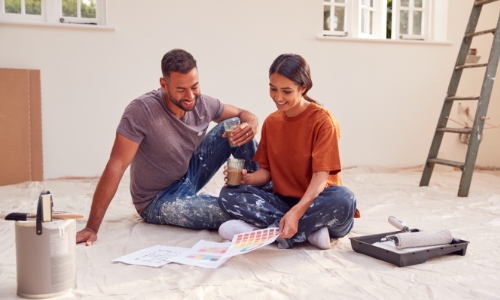 A couple discussing paint colors for a room